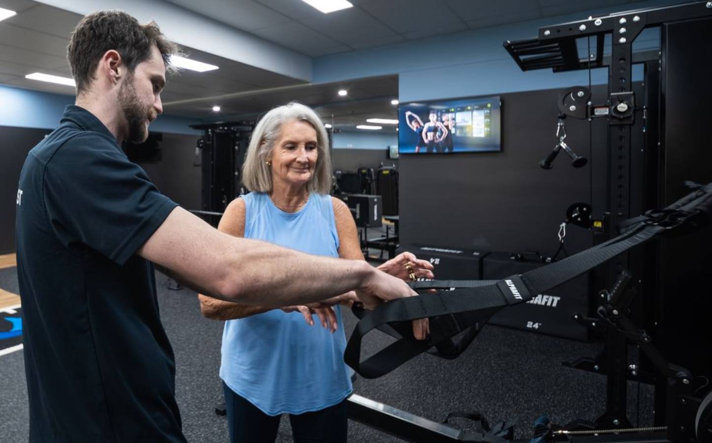 Club Active clinician guiding a member through a strength exercise on the club floor